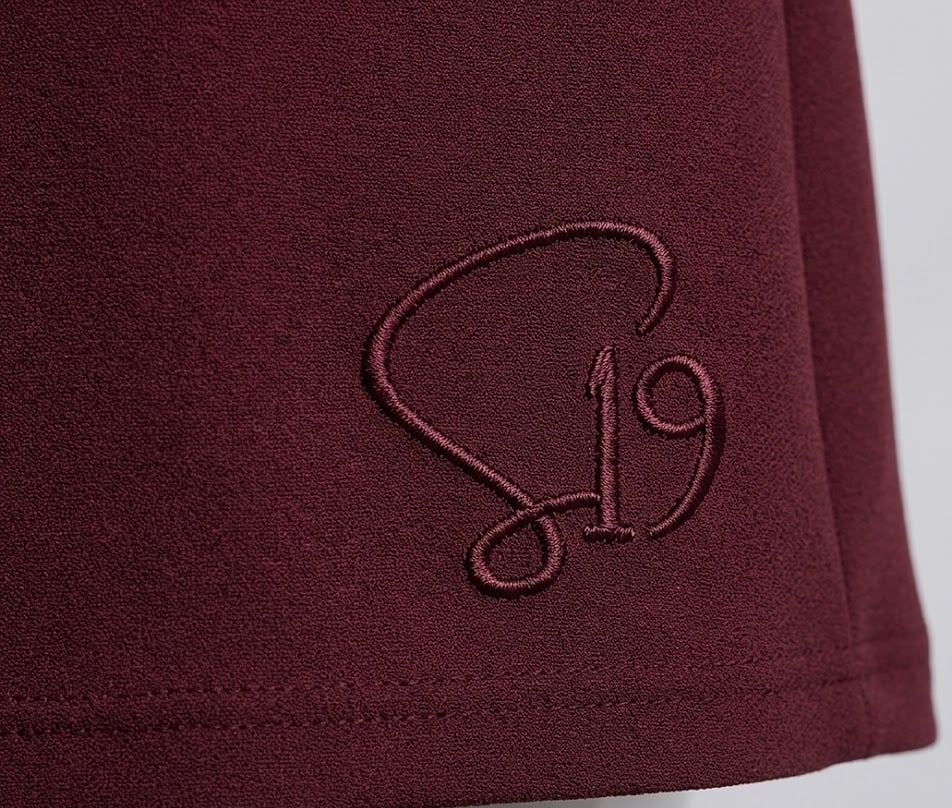 Tonal S19 embroidery on deep maroon fabric